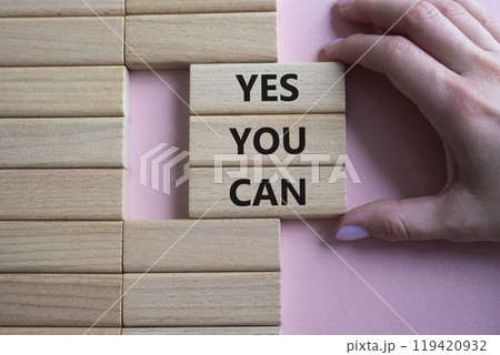 Yes You Can symbol. Concept word Yes You Can on wooden blocks. Beautiful pink background. Businessman hand. Business and Yes You Can concept. Copy space. Yes You Can symbol. Concept word Yes You Can on wooden blocks. Beautiful pink background. Businessman hand. Business and Yes You Can concept. Copy space. 119420932