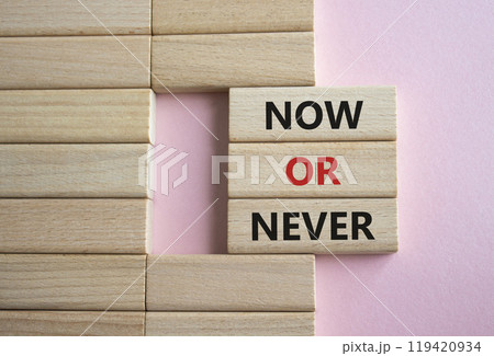 Now or Never symbol. Concept words Now or Never on wooden blocks. Beautiful pink background. Business and Now or Never concept. Copy space Now or Never symbol. Concept words Now or Never on wooden blocks. Beautiful pink background. Business and Now or Never concept. Copy space 119420934