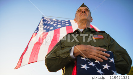 Veteran Soldier Carefully Respecting The Flag Veteran Soldier Carefully Respecting The Flag 119421521