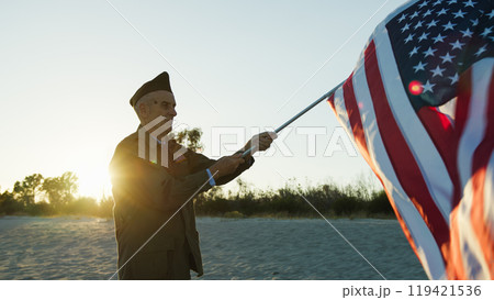 Old Soldier Happily Waving The USA Flag Old Soldier Happily Waving The USA Flag 119421536