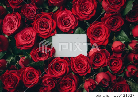 A vibrant arrangement of red roses beside an elegant white card. AI-generated content. 119421627