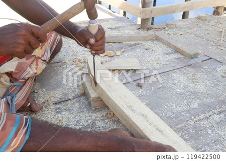 Wooden worker with equipment on farm 119422500