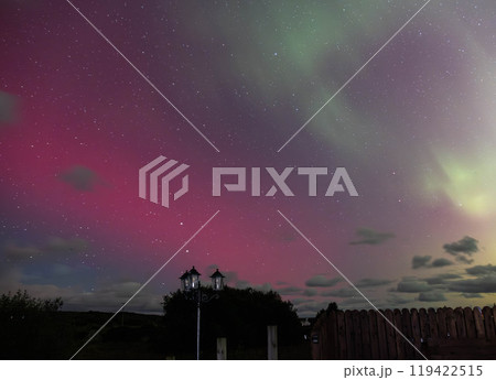 The Aurora Borealis, the northern lights, showing up above fence and lamp in County Donegal, Ireland The Aurora Borealis, the northern lights, showing up above fence and lamp in County Donegal, Ireland 119422515