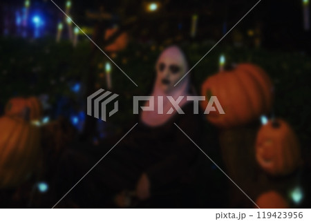 Blur devilish nun sit by pumpkin at night. Halloween costume party 119423956