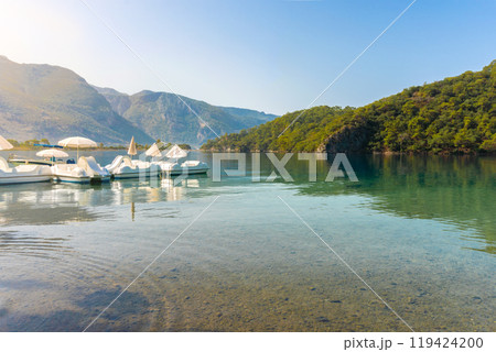 View of Blue Lagoon with Sun Loungers and Umbrellas Along a Tropical Beach on a Clear Summer Day View of Blue Lagoon with Sun Loungers and Umbrellas Along a Tropical Beach on a Clear Summer Day 119424200