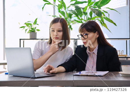 Female psychologist, social worker talking and working with young woman 119427326