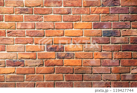 Brick tile wall abstract background. Exterior view of a house made of blocks lined with cement. Exterior wall made of decorative brickwork. 119427744