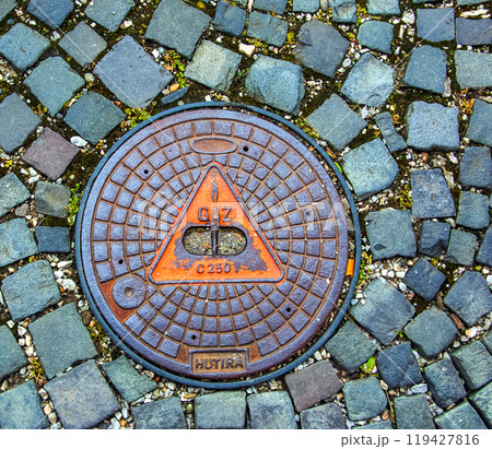 Manhole cover of the gas pipeline system. A massive metal hatch for access to city communications in the pavement. 119427816