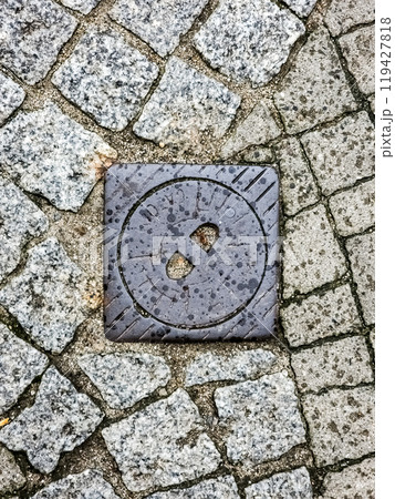 Manhole cover of the gas pipeline system. A massive metal hatch for access to city communications in the pavement. 119427818