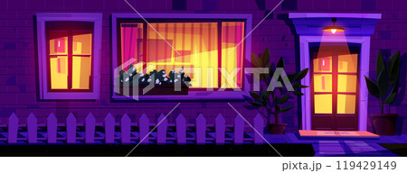 House facade at night with light from windows 119429149