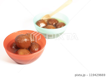 Indian sweets Gulab Jamun in vibrant bowls on white background Indian sweets Gulab Jamun in vibrant bowls on white background 119429669
