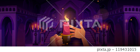 Human hands holding lighted candle in castle hall Human hands holding lighted candle in castle hall 119431015