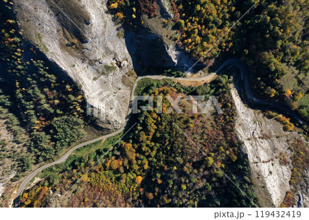 Aerial top down view of deep canyon, gorge road in autumn forest Aerial top down view of deep canyon, gorge road in autumn forest 119432419