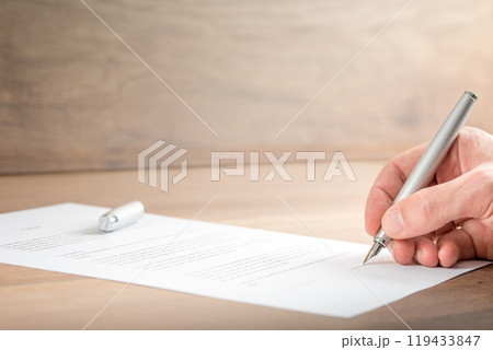 Close up Businessman Signing a Contract Document Close up Businessman Signing a Contract Document 119433847