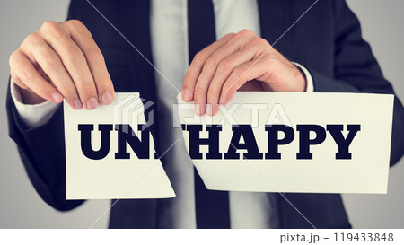 Close up Conceptual Businessman Tearing a White Paper with Unhappy - Happy Message Isolated on a Gray Background 119433848