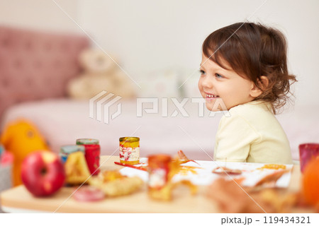 happy little child girl painting autumn leaves. baby girl drawing leaves in yellow paint 119434321