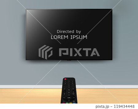 Watching online TV with movie credits on screen. Remote control is pointed at the TV on the wall. 119434448