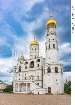 Ivan the Great Bell Tower, with Assumption Belfry on the right in Moscow Kremlin. Blue sky background with sunbeams Ivan the Great Bell Tower, with Assumption Belfry on the right in Moscow Kremlin. Blue sky background with sunbeams 119435746