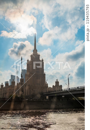 high-rise stalinist building near river at summer sunset in Moscow, Russia. Historic name is Hotel Ukraine. 119435793