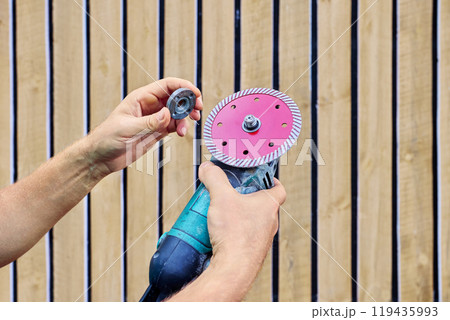 Replacing diamond wheel on an angle grinder before cutting concrete. Replacing diamond wheel on an angle grinder before cutting concrete. 119435993