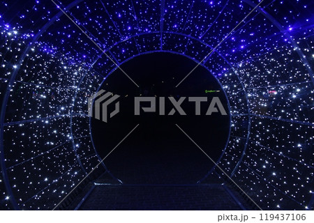 tunnel and illuminations of blue white on a black dark background. New Year's Eve Christmas. Photoona festive atmosphere. 119437106