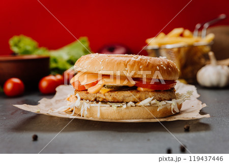 Delicious chicken burger with cheese and fresh toppings. Fast food lovers and marketing campaigns Delicious chicken burger with cheese and fresh toppings. Fast food lovers and marketing campaigns 119437446