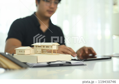 Close up a detailed scale model of a house on architect workspace 119438746