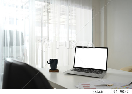 Laptop with blank screen, financial documents and cup of coffee on white table Laptop with blank screen, financial documents and cup of coffee on white table 119439027