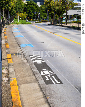 車道の左端に設置された自転車ナビマーク（白色）と自転車ナビライン（青色） 119439397