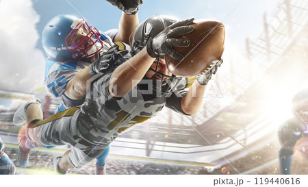 American football. Fighting for the ball in flight. Sport action. Fight. Sport emotion. Sports arena with fans. Bright American football. Fighting for the ball in flight. Sport action. Fight. Sport emotion. Sports arena with fans. Bright 119440616
