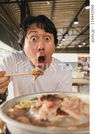 Funny wow face man feeling excited with the delicious Thai BBQ buffet. 119442006