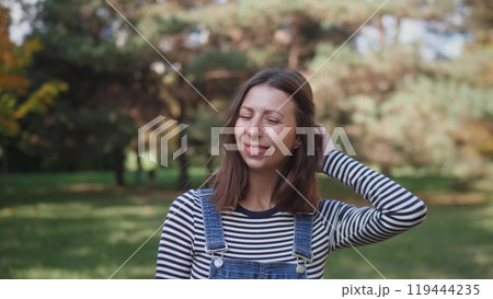 Portrait of a joyful middle-aged woman in a park 119444235