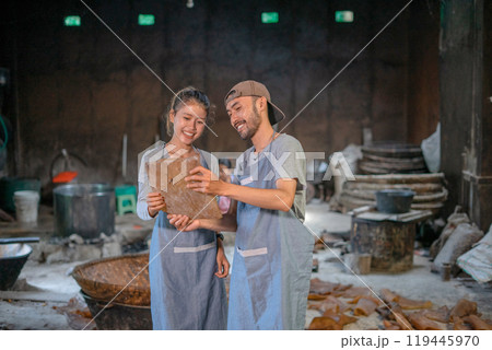 Joyful Artisan Duo Crafting Traditional Goods in Vibrant Workshop Setting 119445970