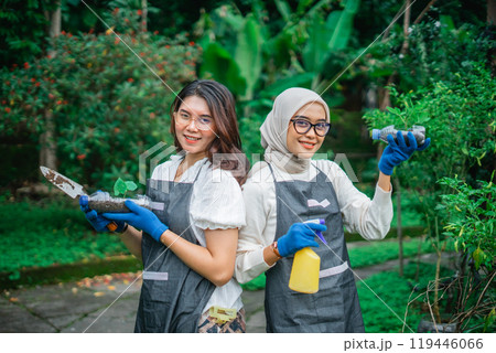 asian women holding vegetable seedling and shovel 119446066