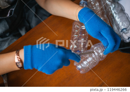 woman hand holding cutter for cutting plastic bottle 119446266