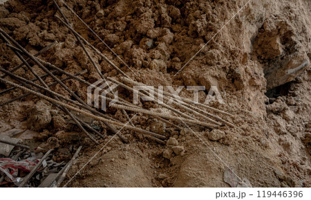 Large pile of earth in which there are many metal reinforcement bars 119446396