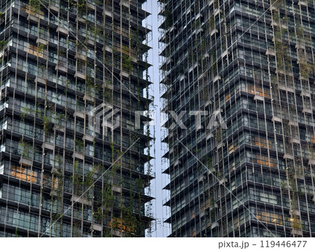 A very tall building that features numerous windows and many balconies A very tall building that features numerous windows and many balconies 119446477