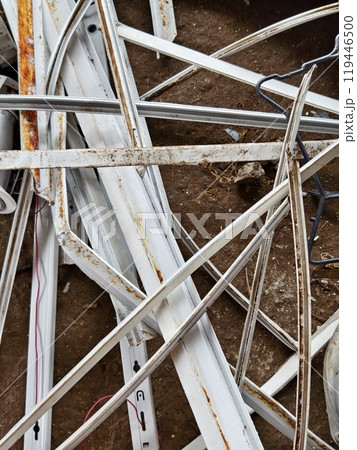 A pile of garbage with a bucket, rope, bottles, and other items at a landfill 119446500