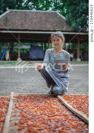 Traditional Crafting in Nature: Woman Engaged in Colorful Textile Production Traditional Crafting in Nature: Woman Engaged in Colorful Textile Production 119446624