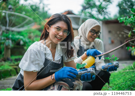 asian women holding vegetable seedling in the garden asian women holding vegetable seedling in the garden 119446753