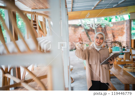 A Cheerful Young Woman in a Cozy and Inviting Woodworking Space Creating Beautiful Items A Cheerful Young Woman in a Cozy and Inviting Woodworking Space Creating Beautiful Items 119446779