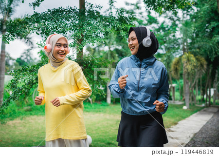 Active and Energetic Women Jogging Together in a Beautiful Green Park Space Active and Energetic Women Jogging Together in a Beautiful Green Park Space 119446819