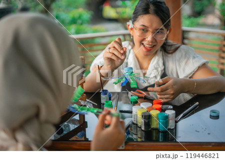 asian women enjoy making handmade craft from plastic waste 119446821