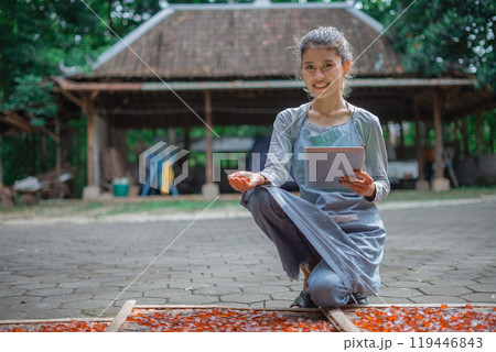 A young woman is engaged in traditional crafting with colorful materials 119446843