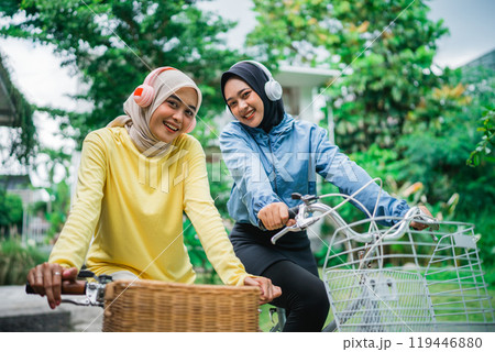 Joyful Friends happily Enjoying a Beautiful Day Outdoors while Riding Bicycles Joyful Friends happily Enjoying a Beautiful Day Outdoors while Riding Bicycles 119446880