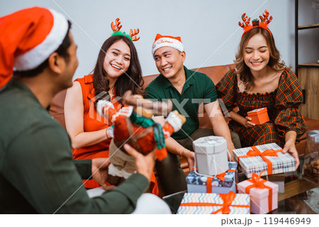 A Joyful and Merry Christmas Gathering with Wonderful Friends and Plenty of Gifts A Joyful and Merry Christmas Gathering with Wonderful Friends and Plenty of Gifts 119446949
