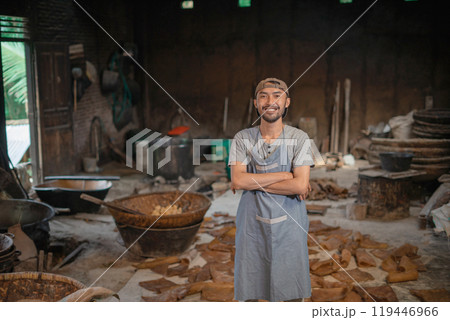 Skilled Artisan in a Rustic Workshop Surrounded by Tools and Materials 119446966