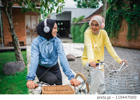 Friends biking on a sunny day, wearing headphones, and making great memories 119447000