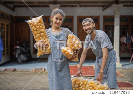 Joyful and Enthusiastic Workers are Packing Freshly Made Pastries in a Local Market Joyful and Enthusiastic Workers are Packing Freshly Made Pastries in a Local Market 119447059