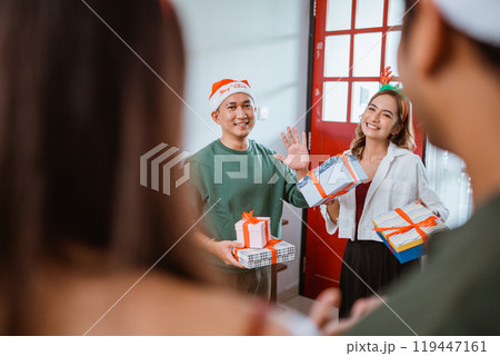 Celebrating Together Sharing Joyful Moments Together with Holiday Gifts and Cheer 119447161